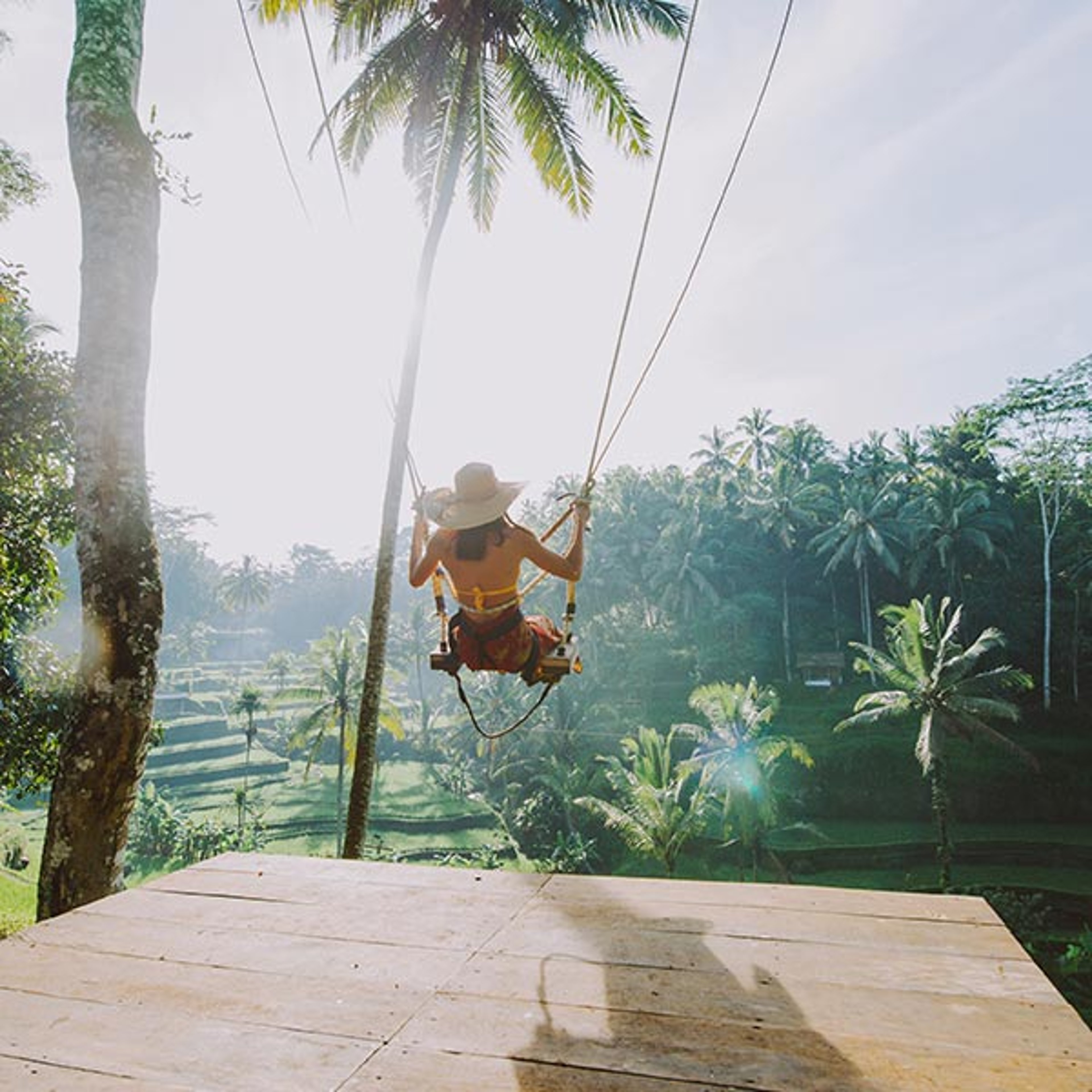 Woman on swing in tropical destination