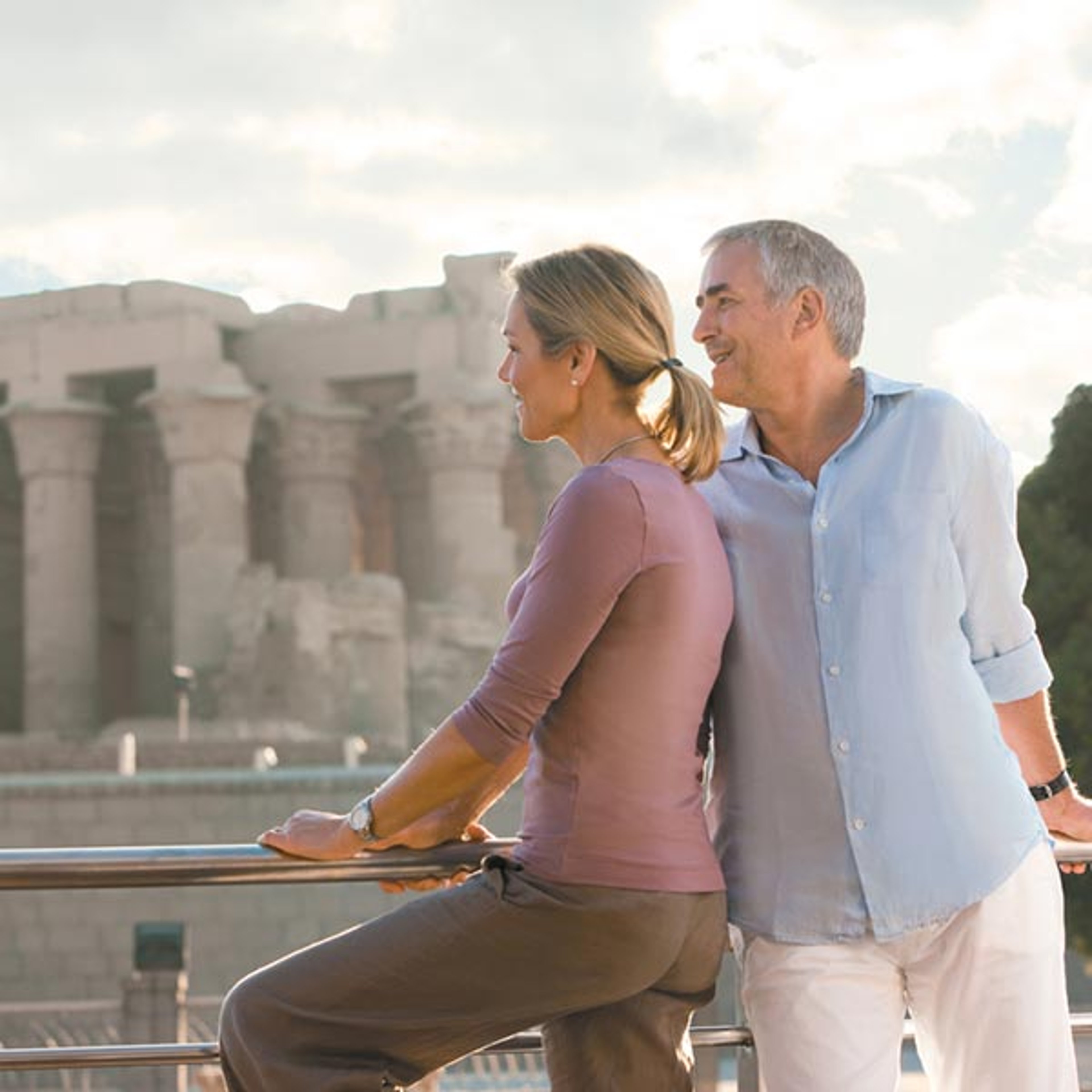 A couple aboard a Uniworld cruise enjoying the sites from the deck