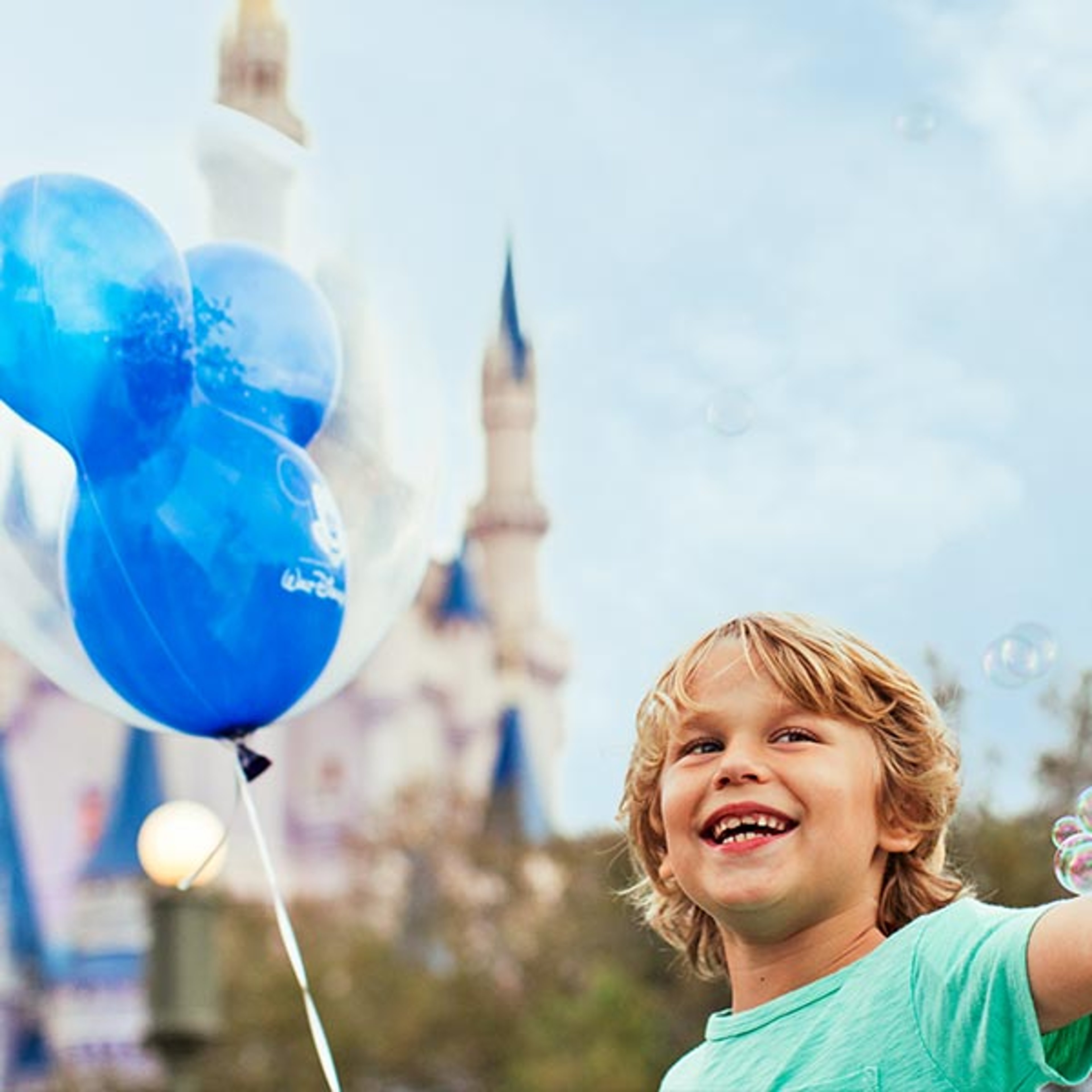 Boy with balloons at Disney
