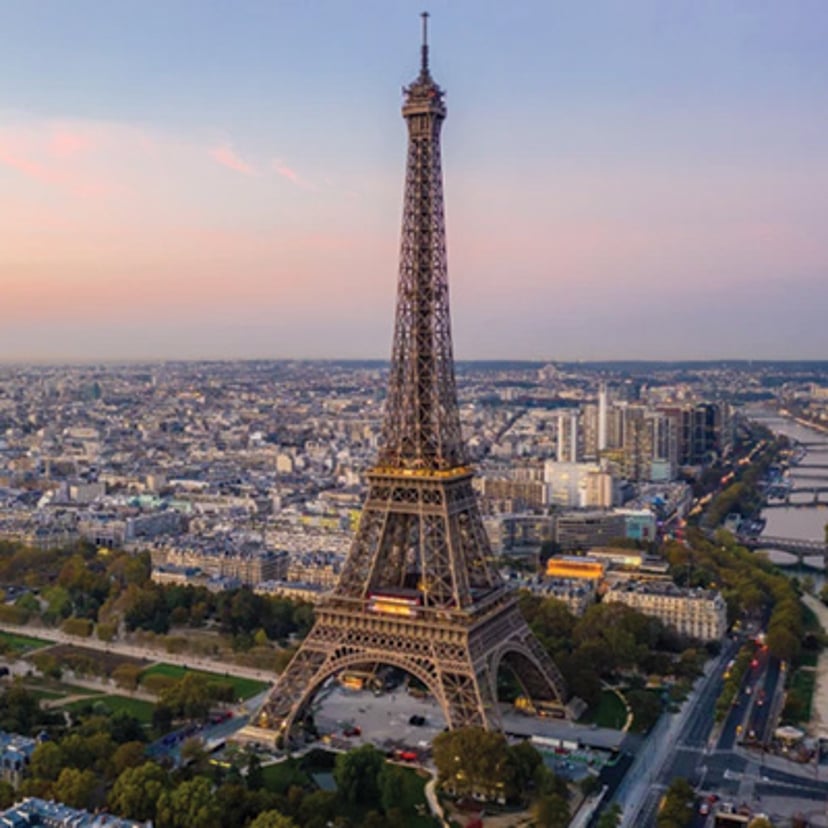 Eiffel Tower overlooking the Paris cityscape at sunset.