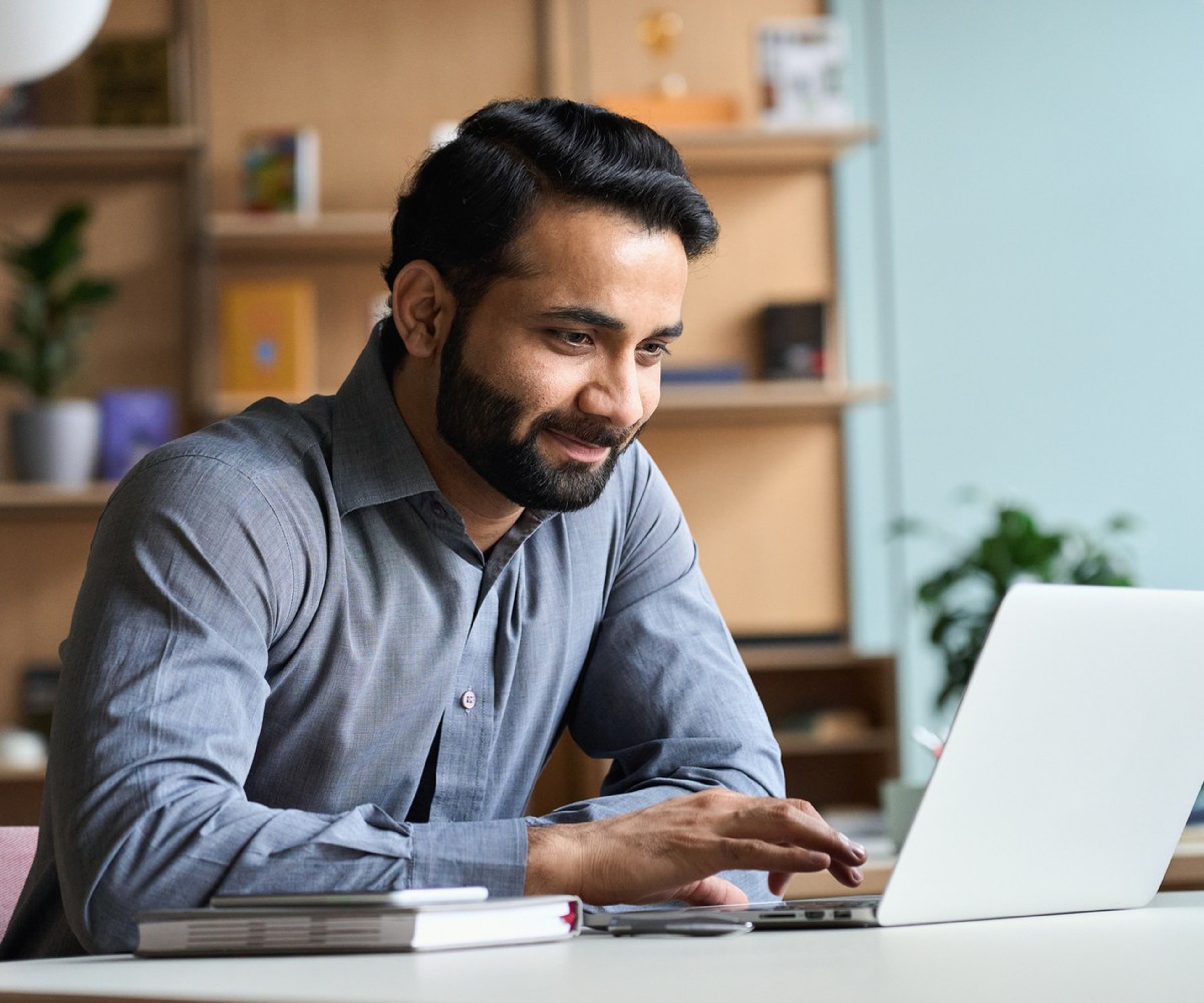 Man using a laptop to complete an online application