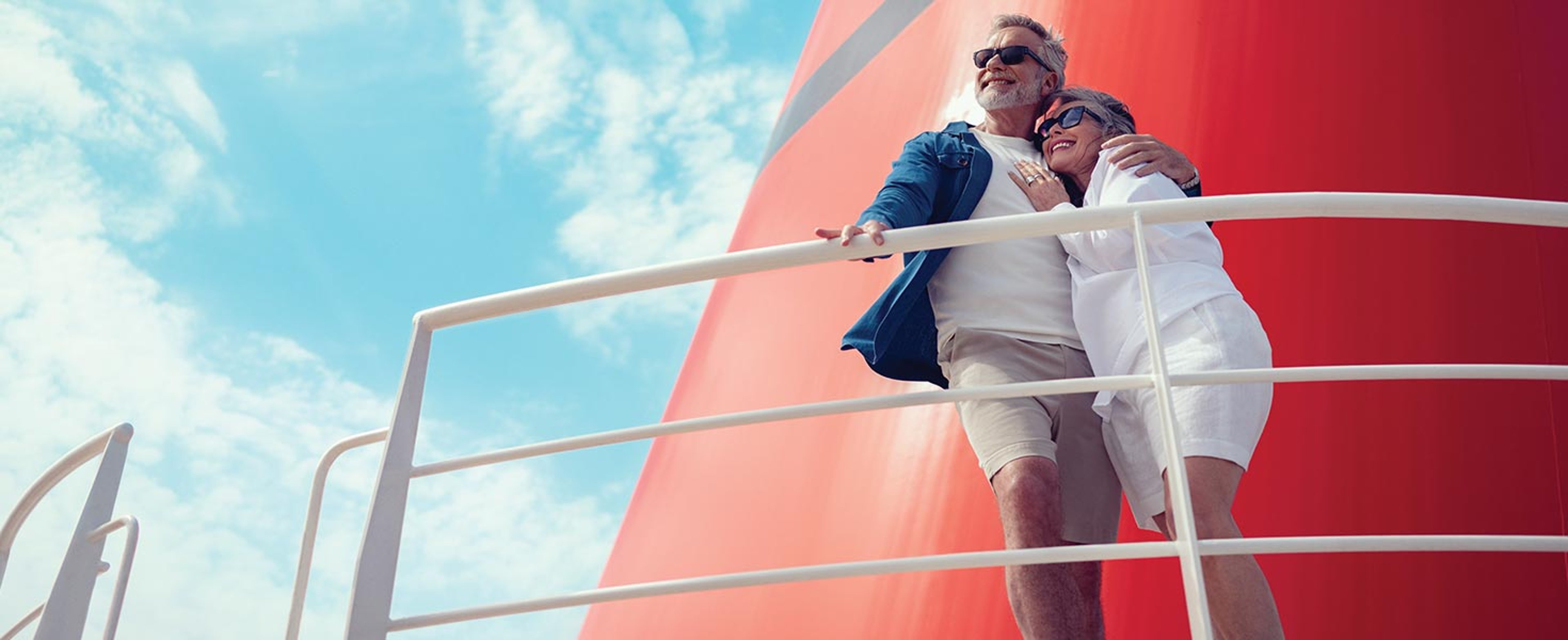 Couple in front of Cunard ship's funnel