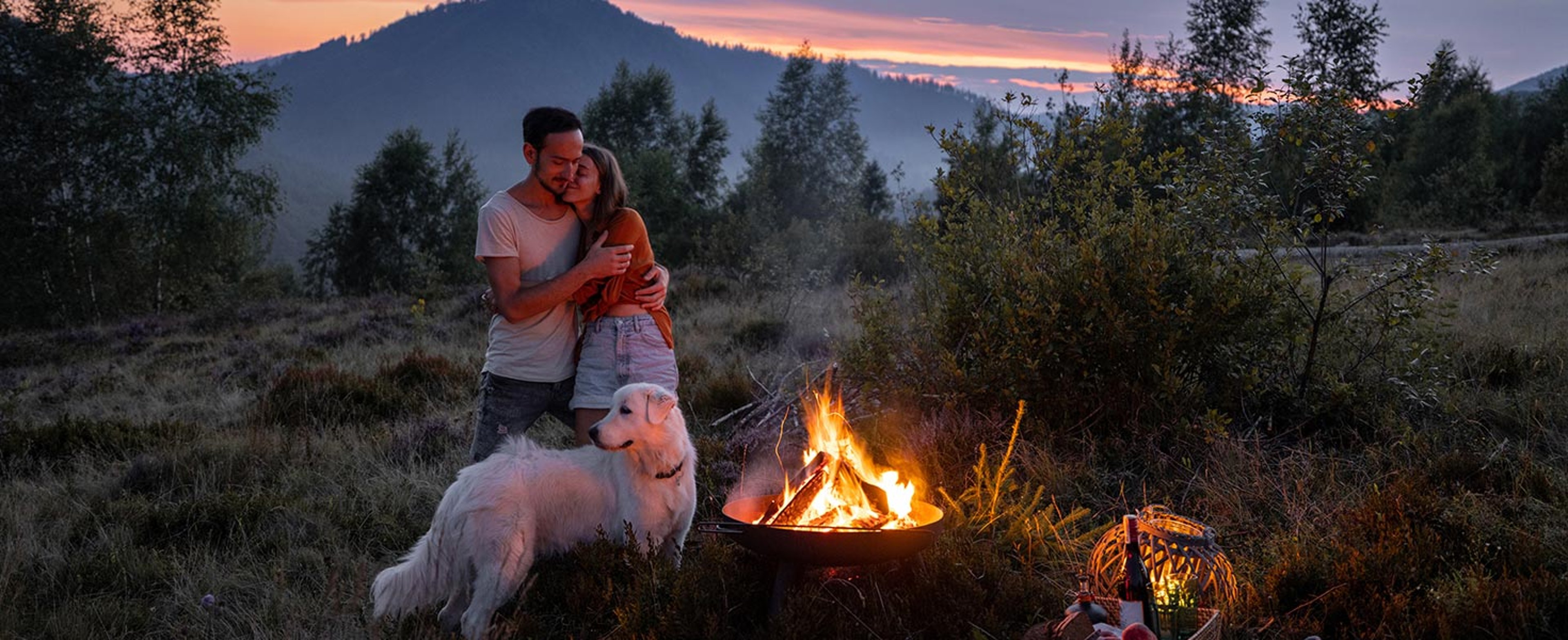 Couple camping with dog