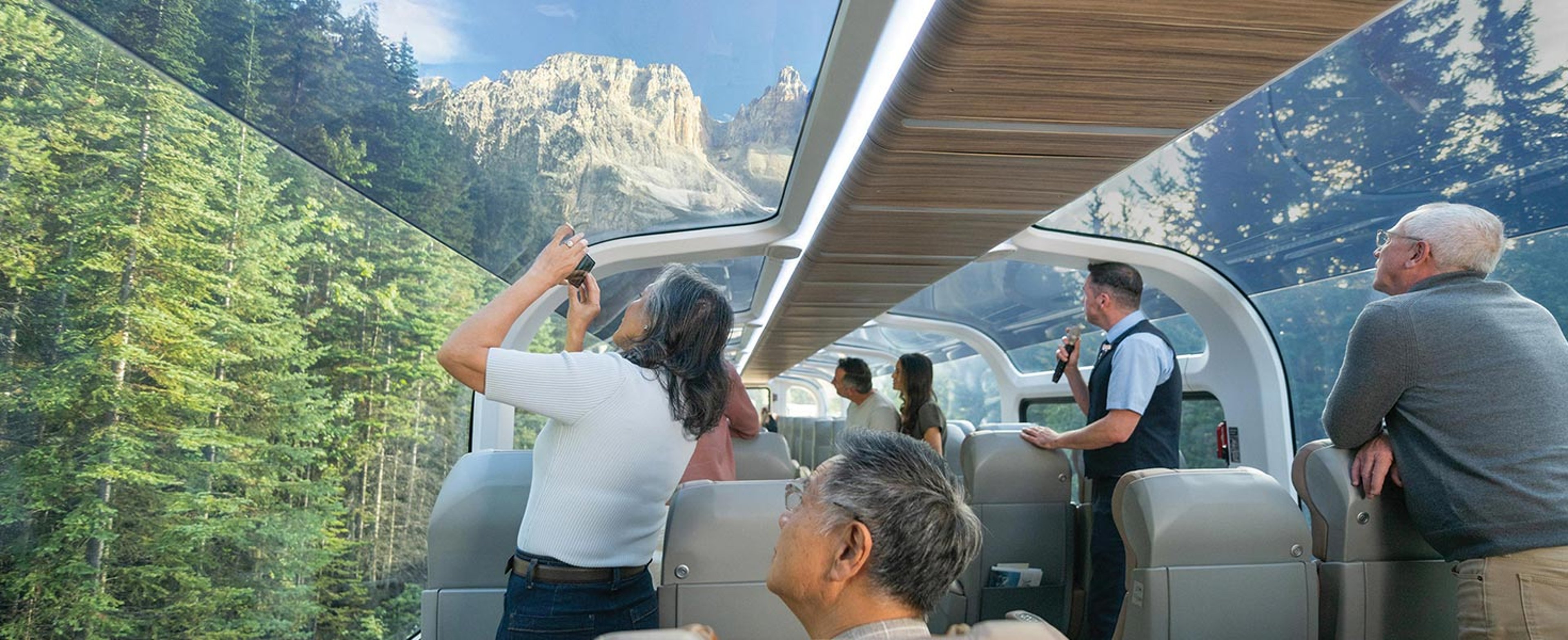 Rocky Mountaineer guests taking photos on train