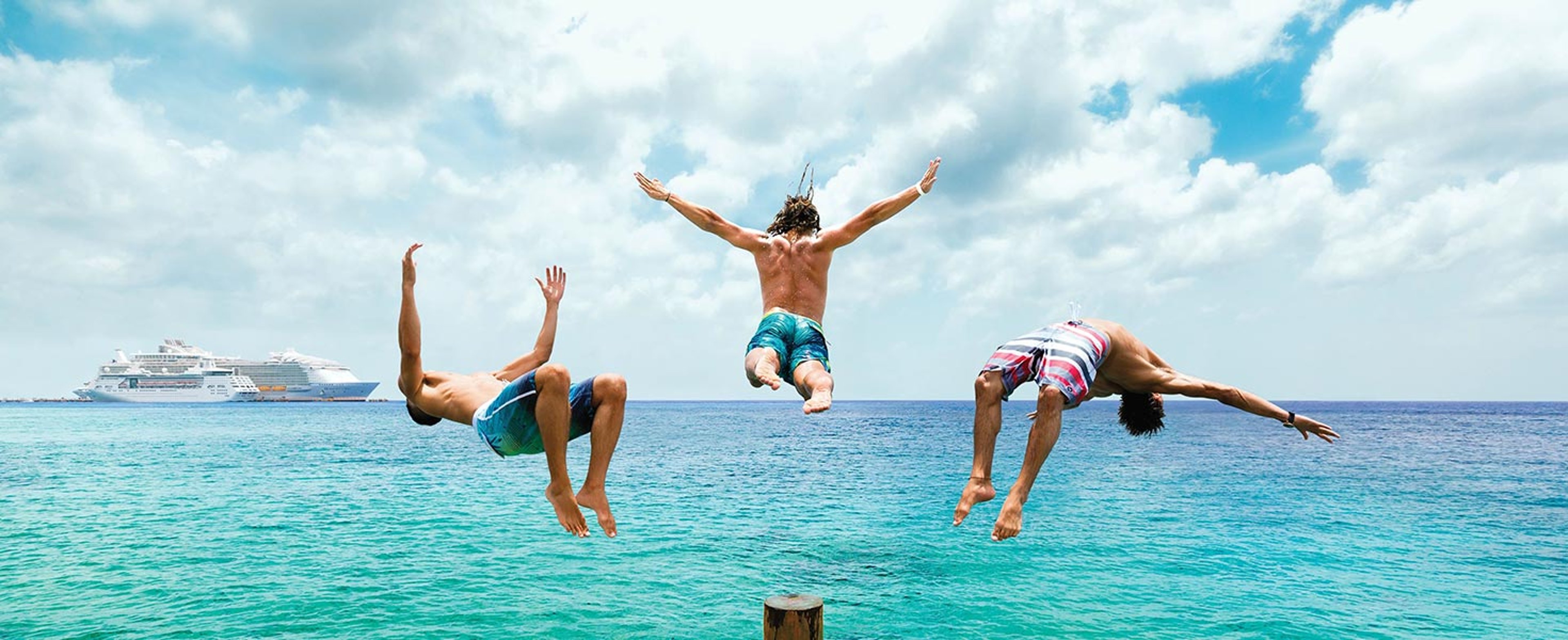 Group of swimmers diving into ocean