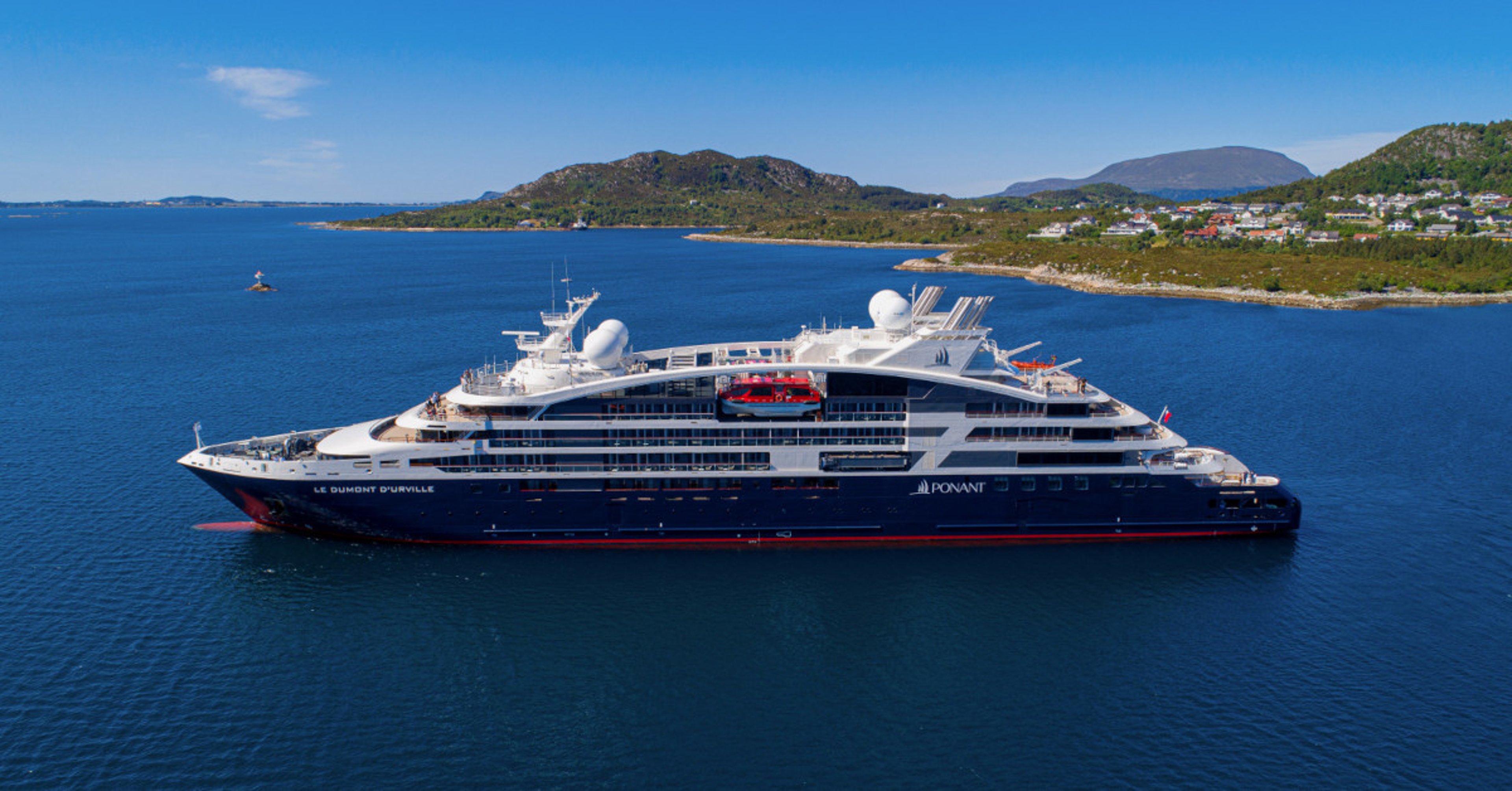 Le Dumont d'Urville Ponant cruise ship anchored off of coast 