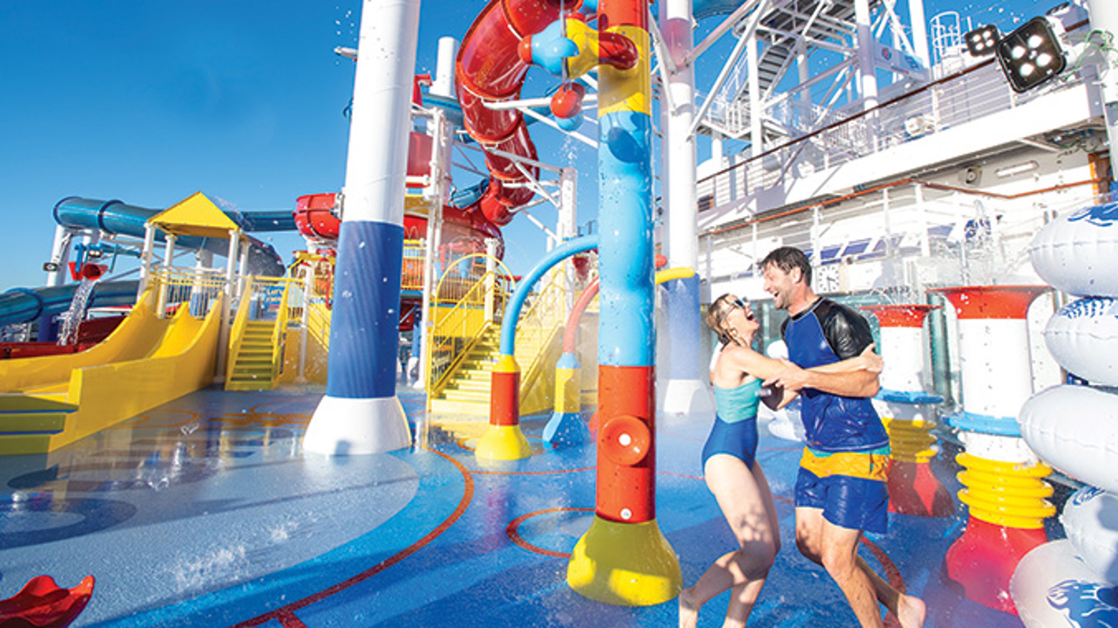 AAA Travel Set Sail Carnival Couple smiling and laughing at waterpark aboard Carnival Cruise Line ship