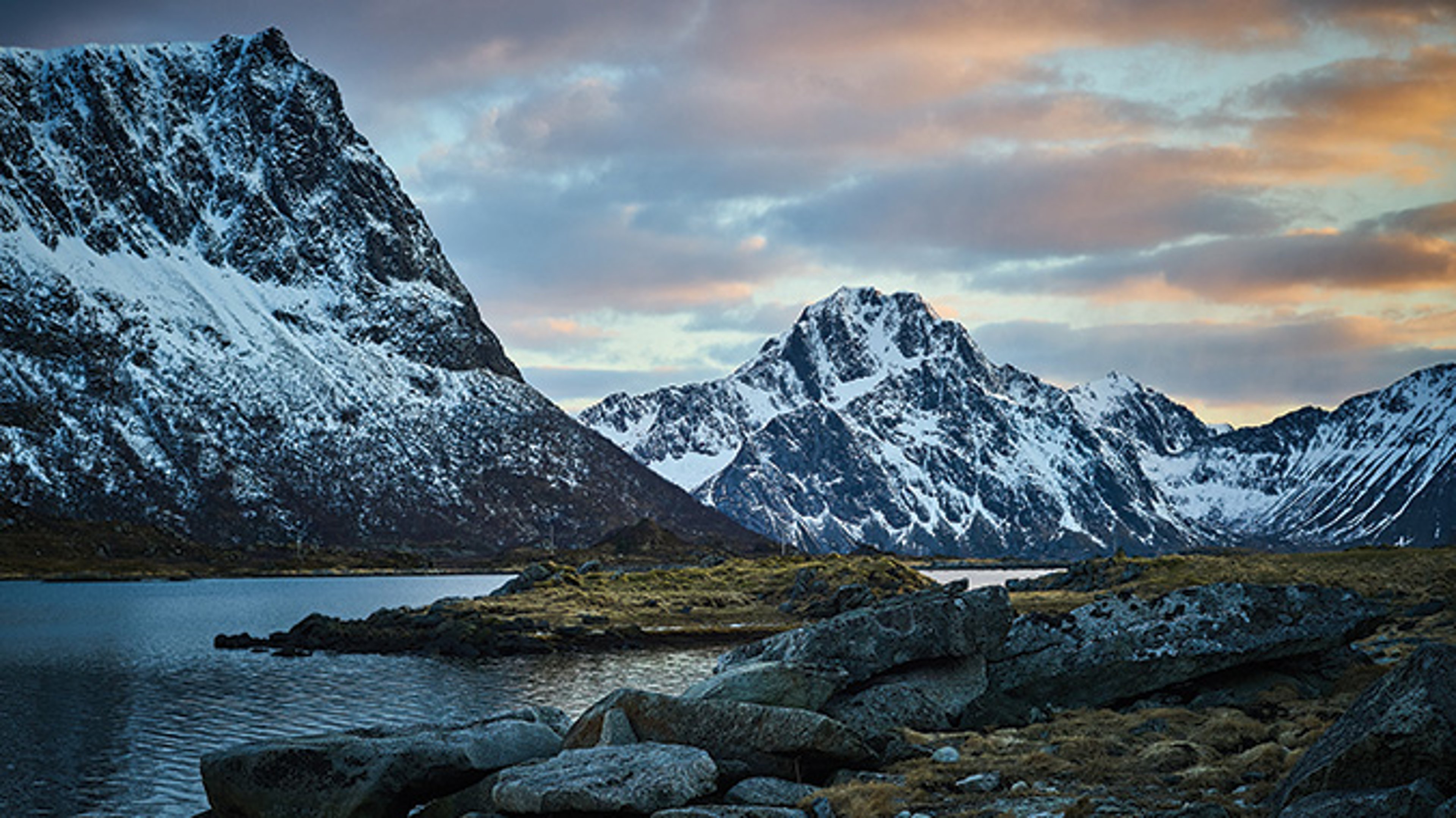 AAA Travel Set Sail Princess Cruises Rock formations beside lake beneath mountains at sunset