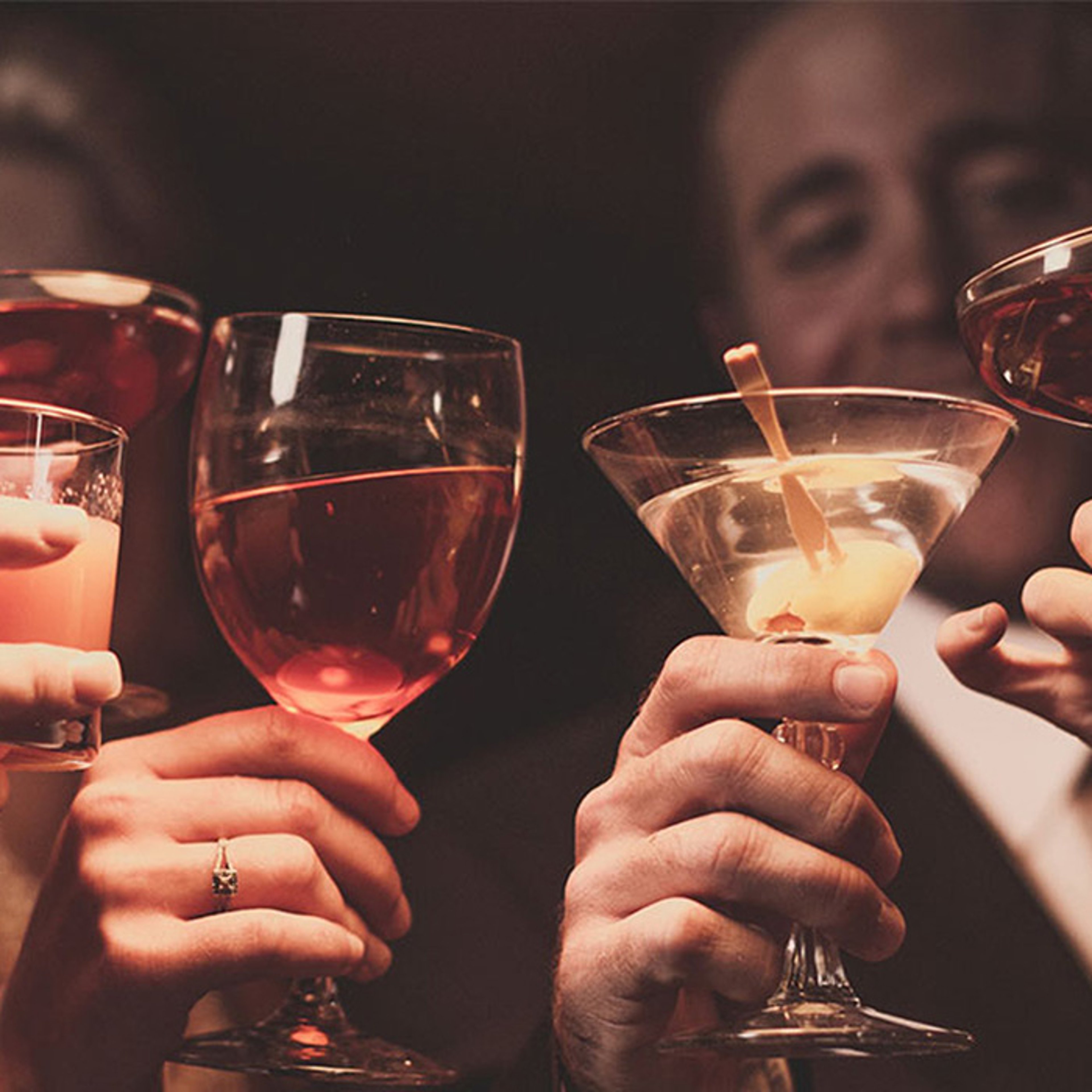Group of friends toasting drinks while dining on cruise