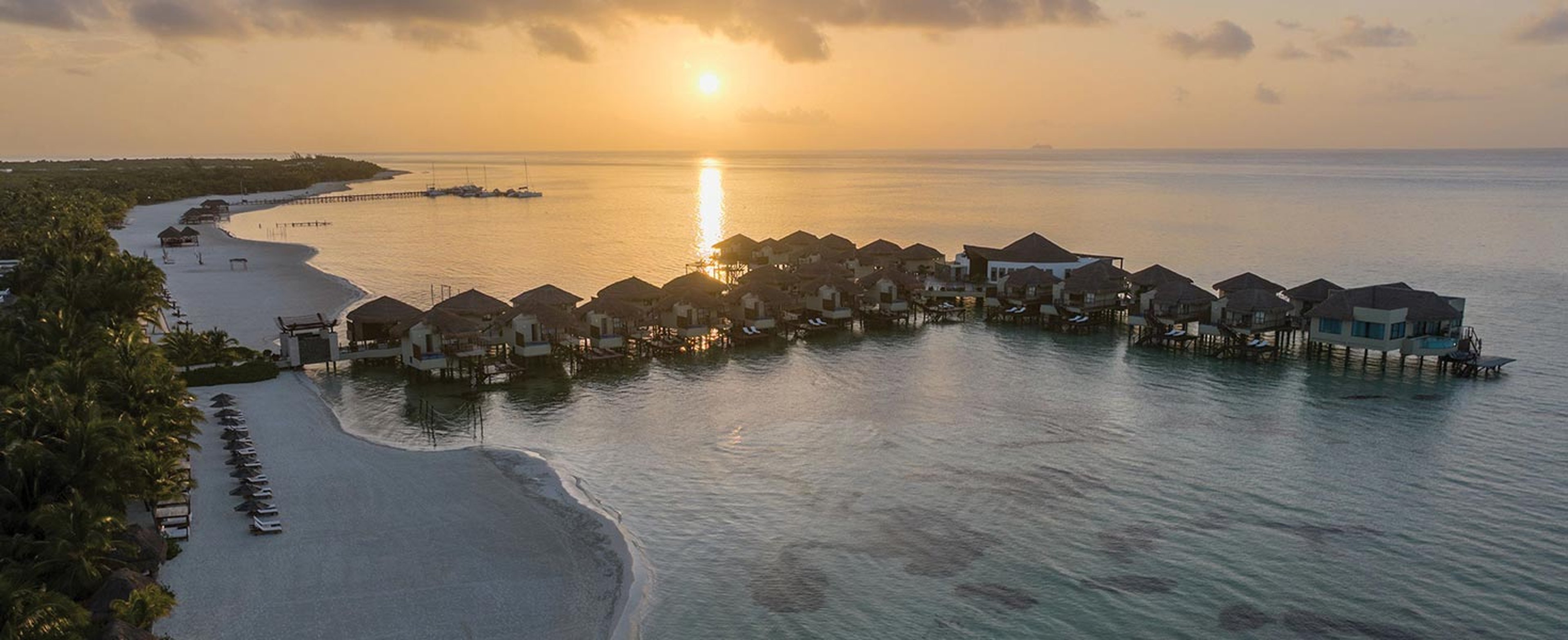 Beach cabanas over the water in Riviera Maya