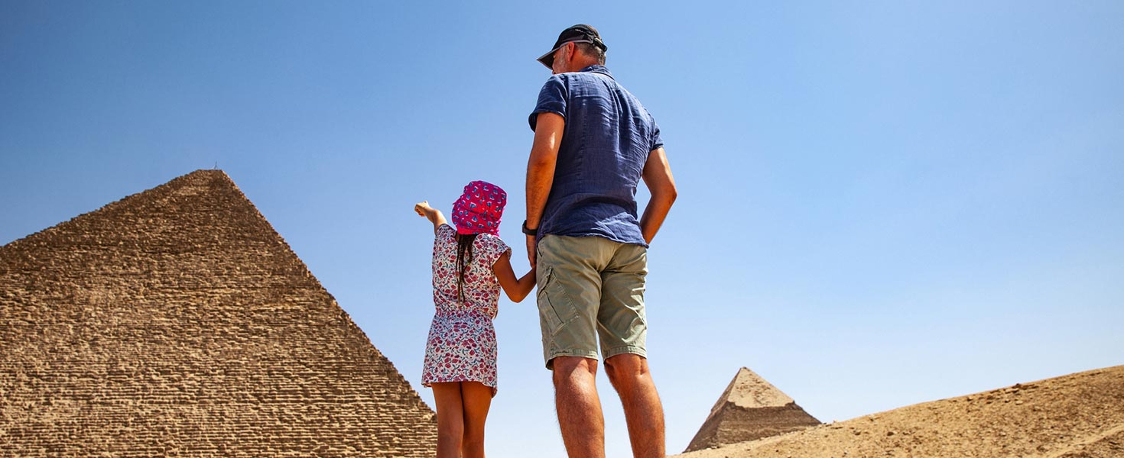 Dad and daughter visiting the pyramids
