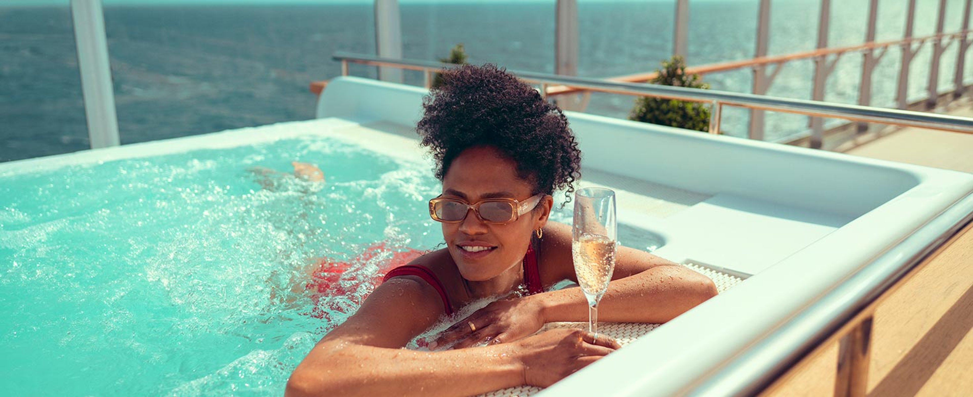 Woman enjoying a hot tub aboard a Cunard ship