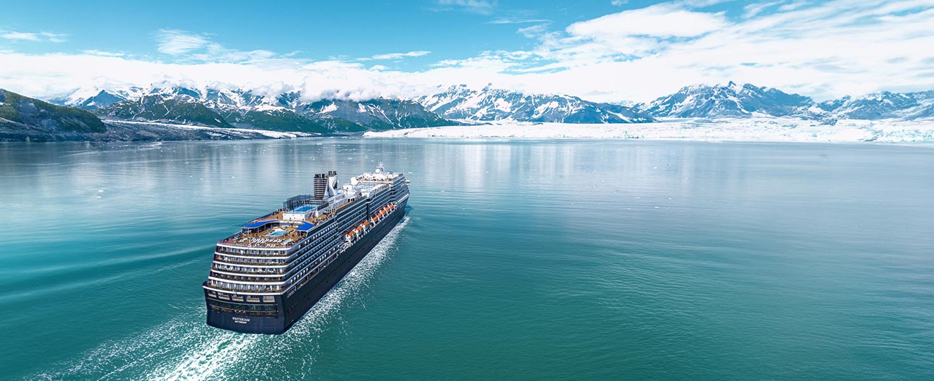 Holland America ship sailing along Alaska coastline