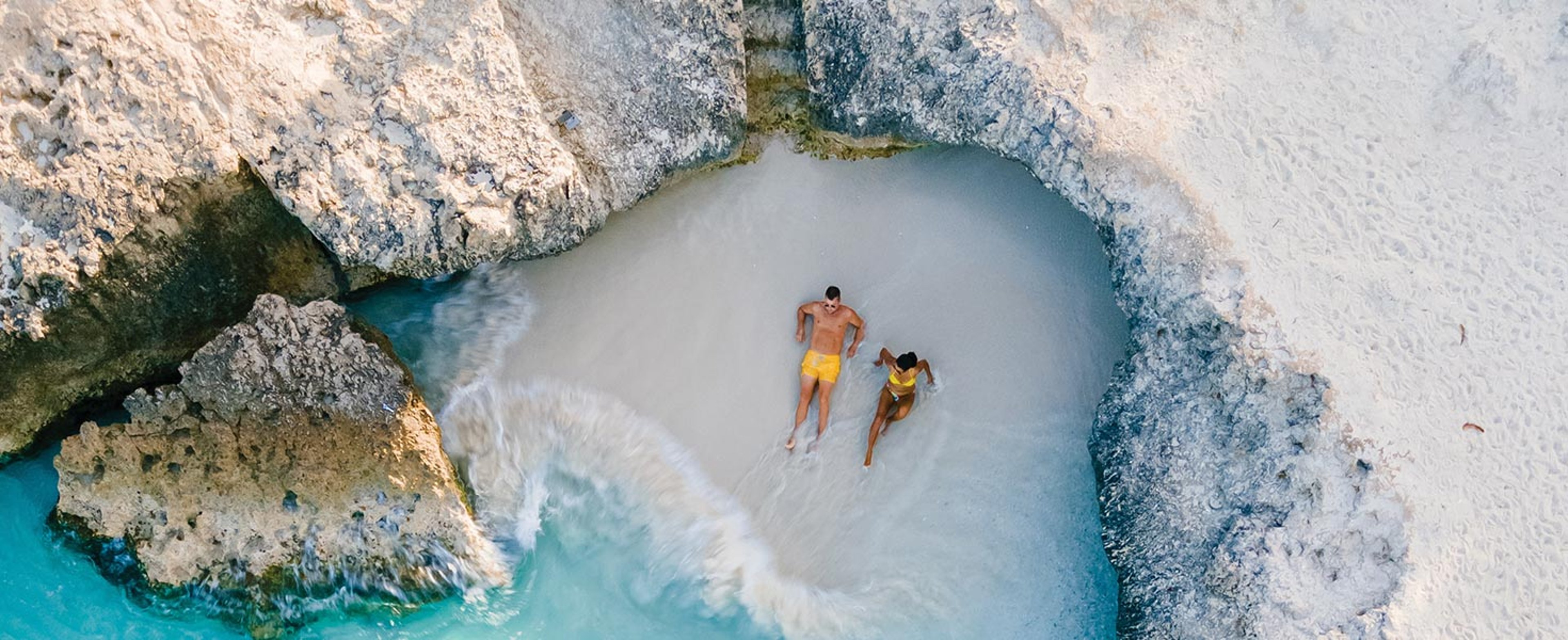 couple relaxing on white sandy beach