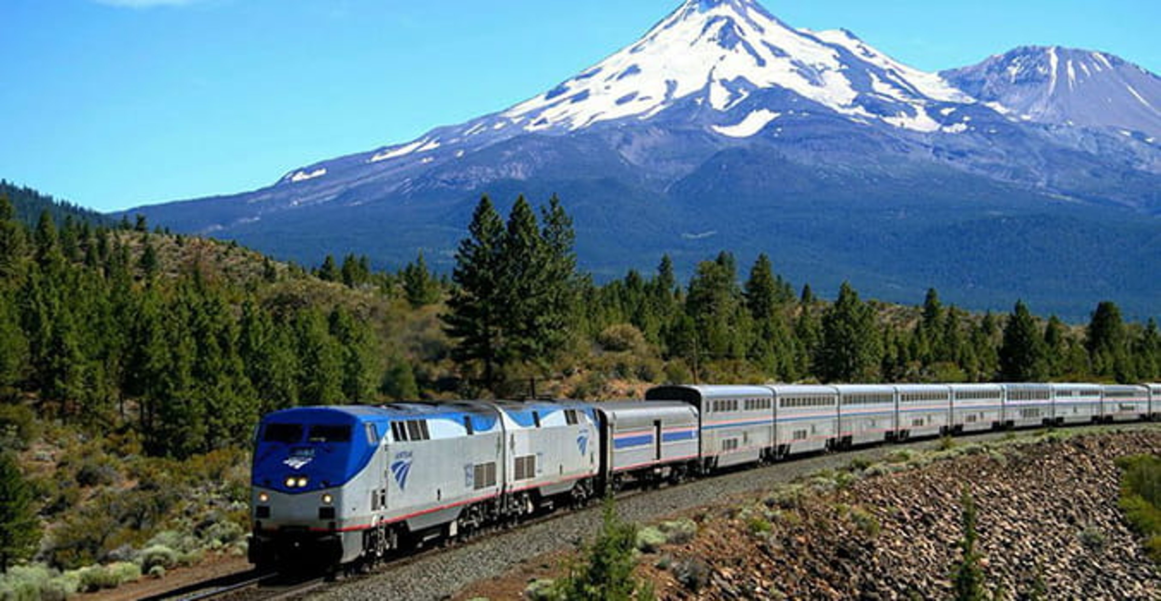 Amtrak train with a mountain in the background