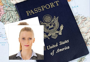 Two passport photos on top of a US passport, on top of a world map