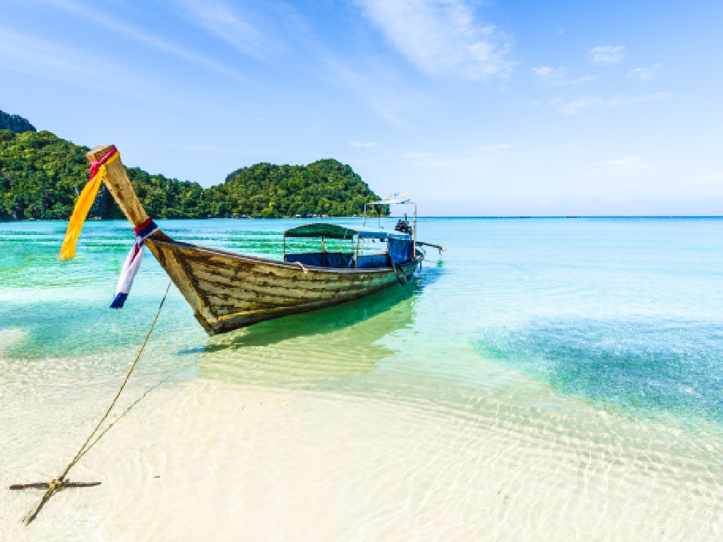 Small boat anchored on a beautiful beach