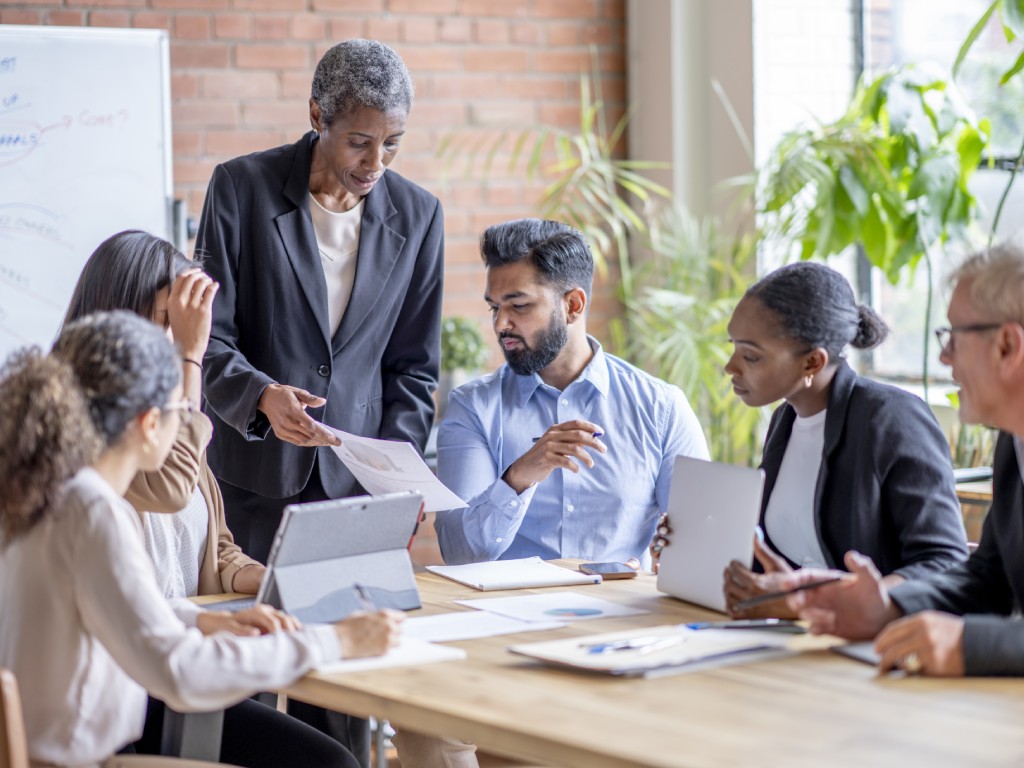 Business associate presenting documents at a meeting