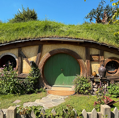 Hobbit house with green door on Hobbiton movie set in Auckland, New Zealand