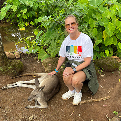 Martin Travel advisor Judy Miron posing with a kangaroo under tree in Melbourne, Australia