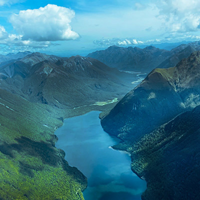 Aerial view of lush mountainscapes and blue waters of Milford Sound on New Zealand's South Island