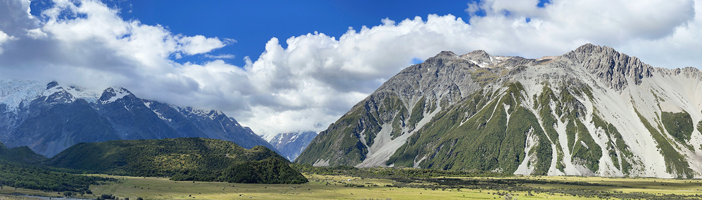 Panoramic view of Mount Cook Aoraki under blue sky with clouds in New Zealand's Southern Alps