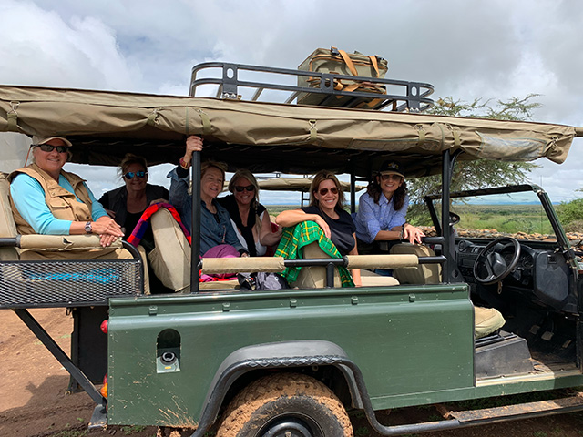 Group on safari in green truck