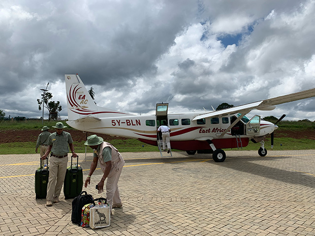 Wing safari plane and travelers with luggage