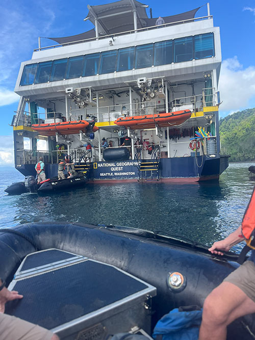 small zodiac boat approaching National Geographic ship