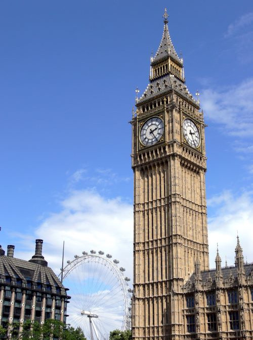 Big Ben and London Eye under blue skies