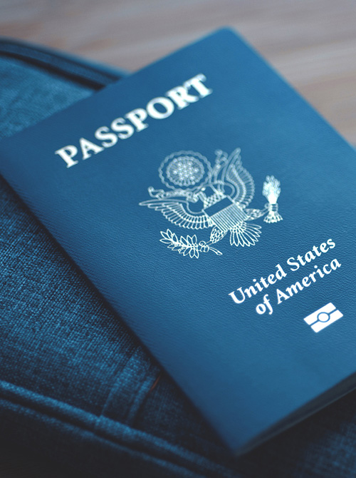 US passport rests on travel toiletry bag