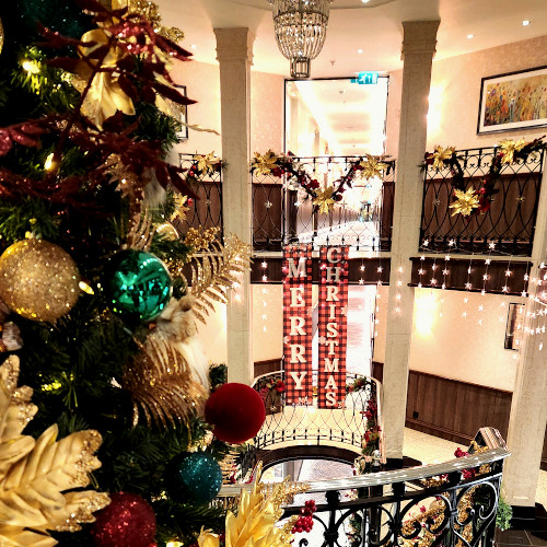 Interior of Tauck Christmas river cruise ship decorated with festive holiday decor