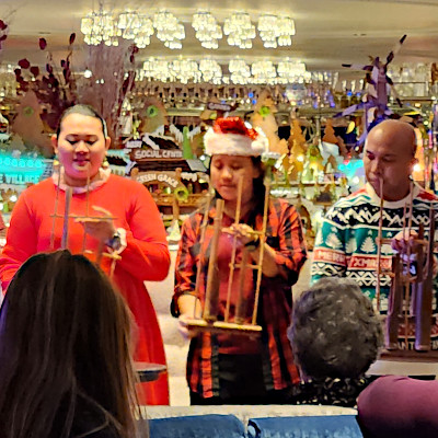 Crew in festive holiday attire performing on the Tauck Christmas Cruise Rhine
