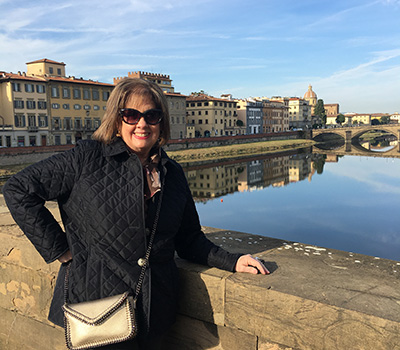 Provident Travel advisor Janet McLaughlin standing on bridge overlooking Venetian canal