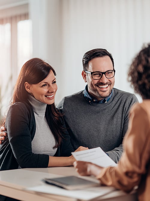 Couple meeting with a travel advisor to discuss and plan their vacation.