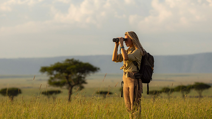 Woman sightseeing during a safari trip with backpack
