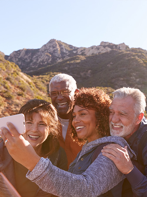 Group of friends posing for selfie while traveling