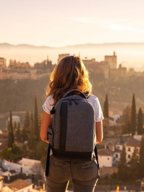 Traveler with backpack overlooking city view