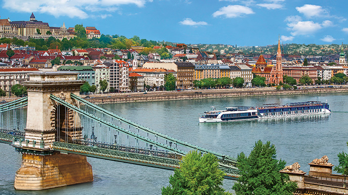 Cruise ship passing under the scenic Chain Bridge in Budapest, Hungary along the Danube River