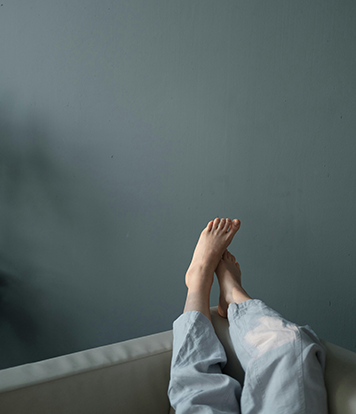Girl with feet up the wall