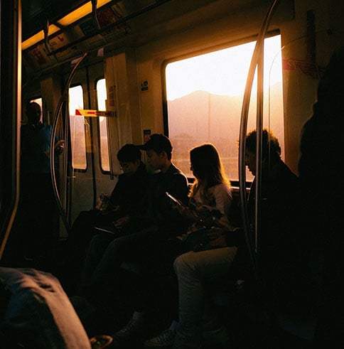 People on the SkyTrain at sunset