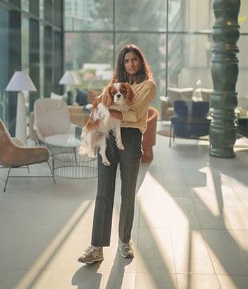 Girl with a cavalier puppy in building lobby 