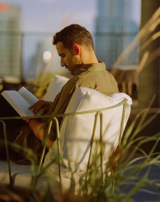 Man reading on a chair outside