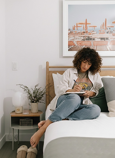 Girl sitting on bed reading