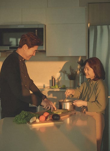 Couple chopping vegetables in the kitchen