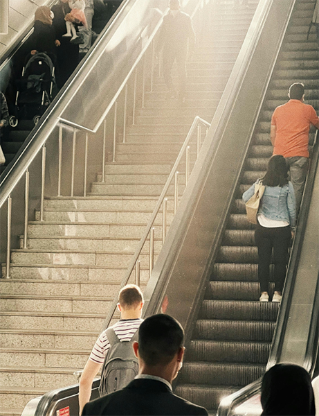 People going up an escalator