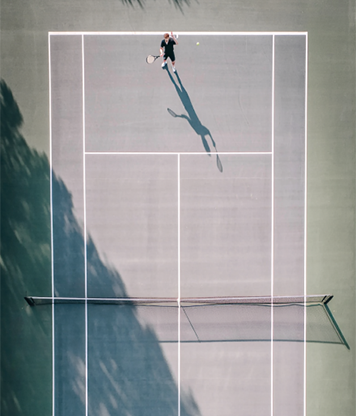 Man playing tennis outside