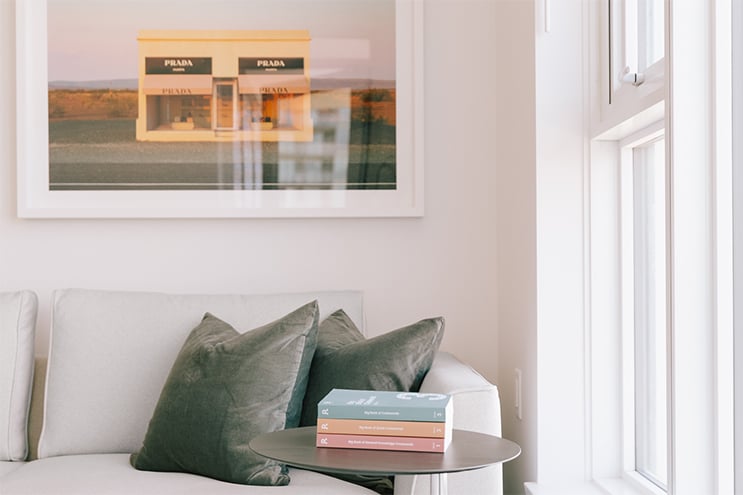 Close up of a couch with artwork hanging above