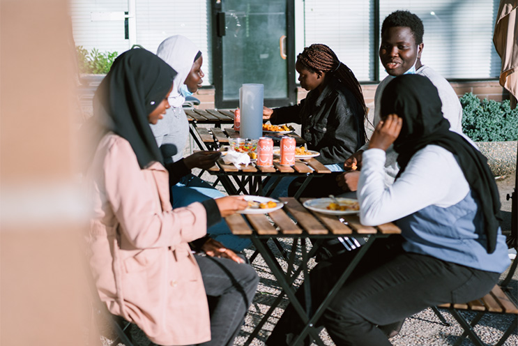 People sitting around table outside