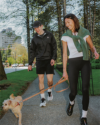 Couple walking their dog among the greenery